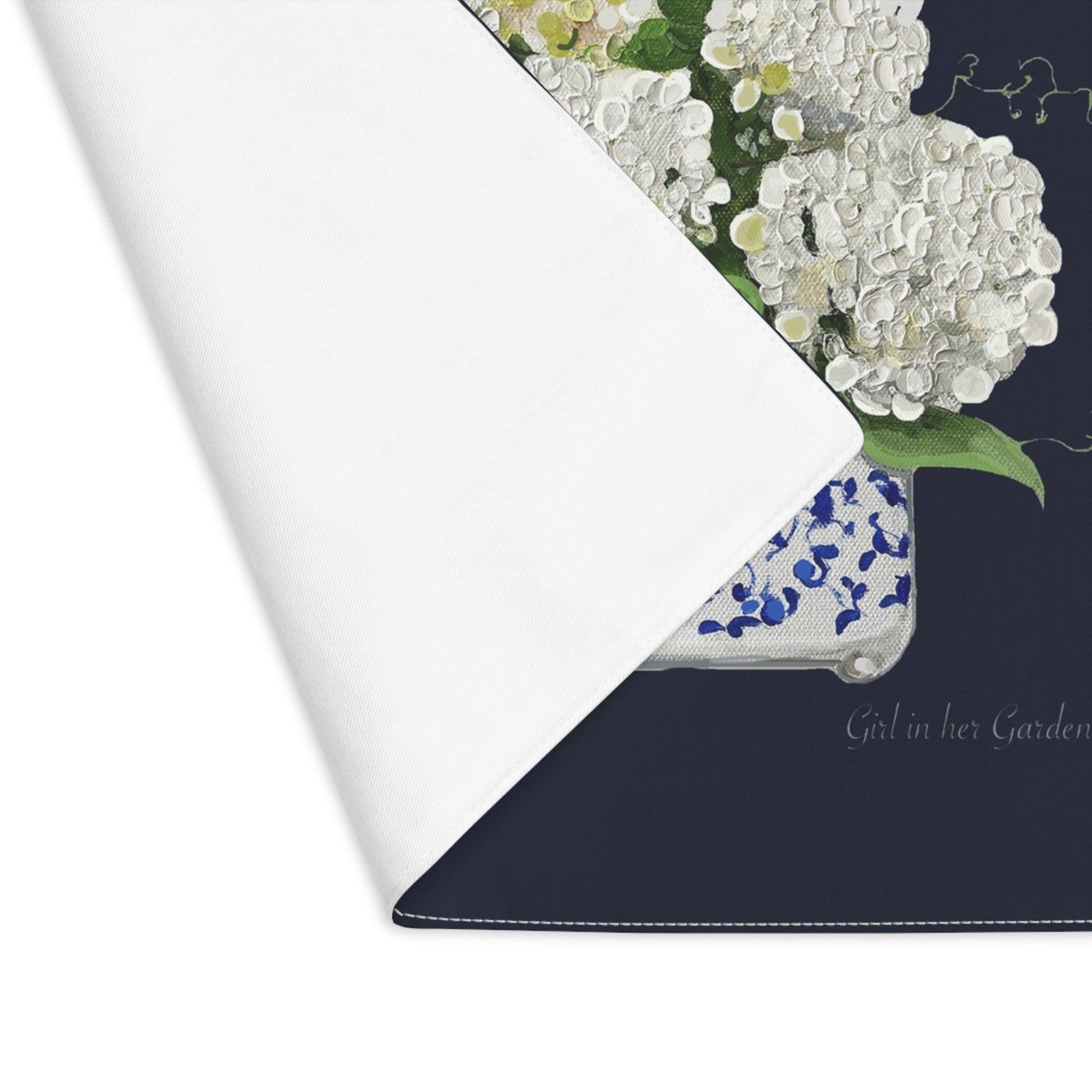Floral-patterned product with 'Girl in Her Garden' branding on a white background