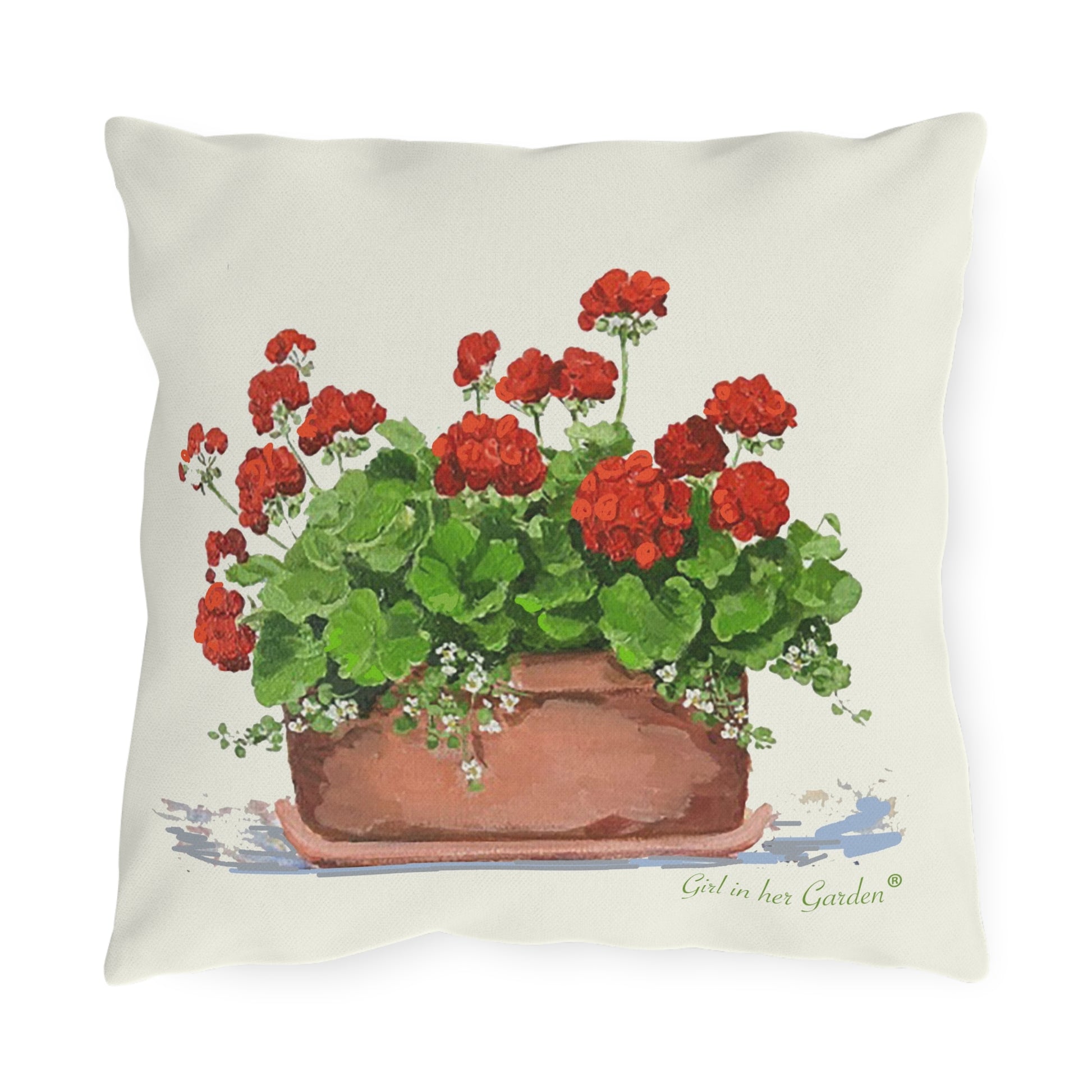 Outdoor pillow with red geranium floral design in a brown pot on a white background.