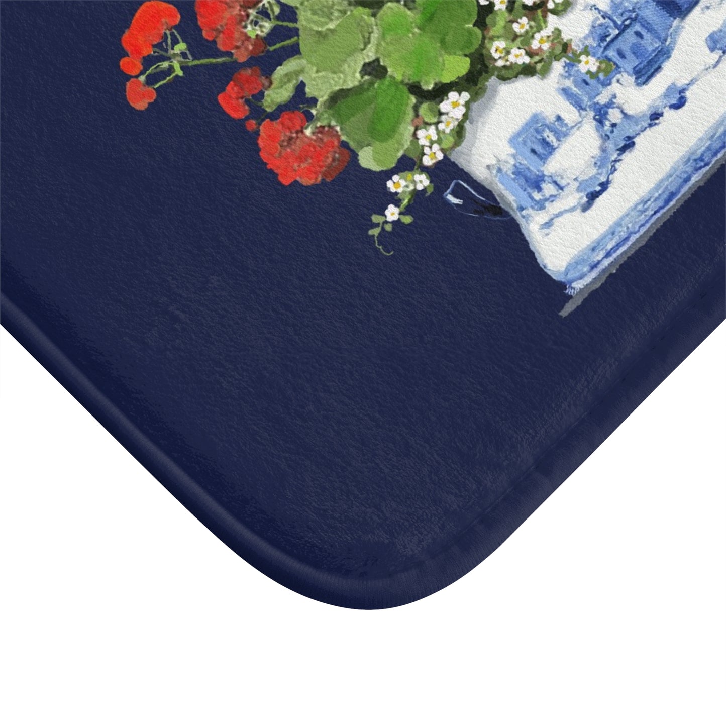 Navy blue bath mat with floral design on a white background