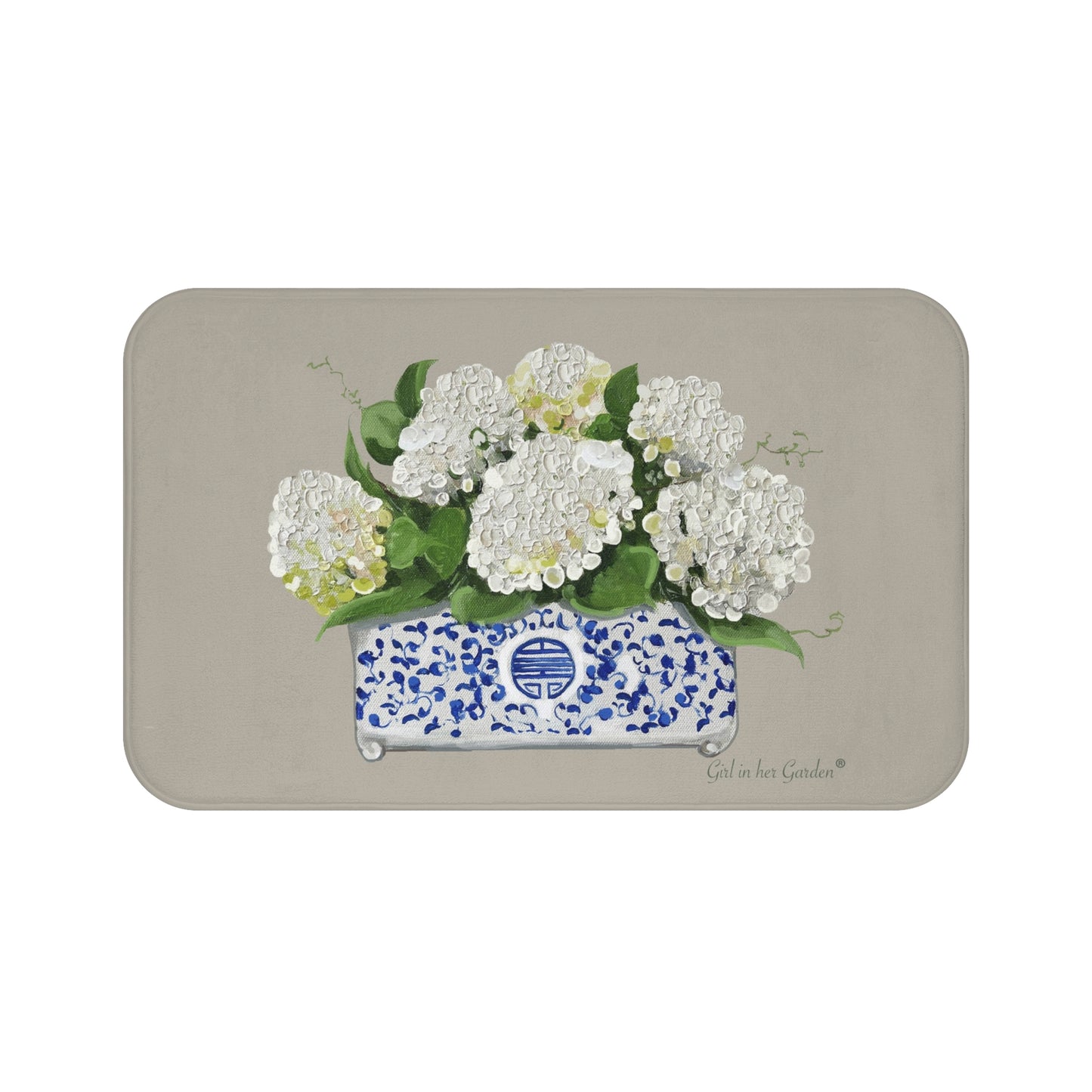 Decorative mat with white flowers in a blue and white container on a beige background