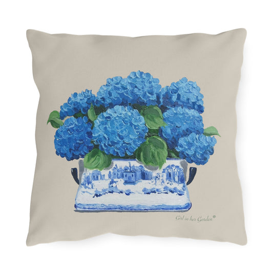 Pillow with blue hydrangeas in a white vase on a beige background