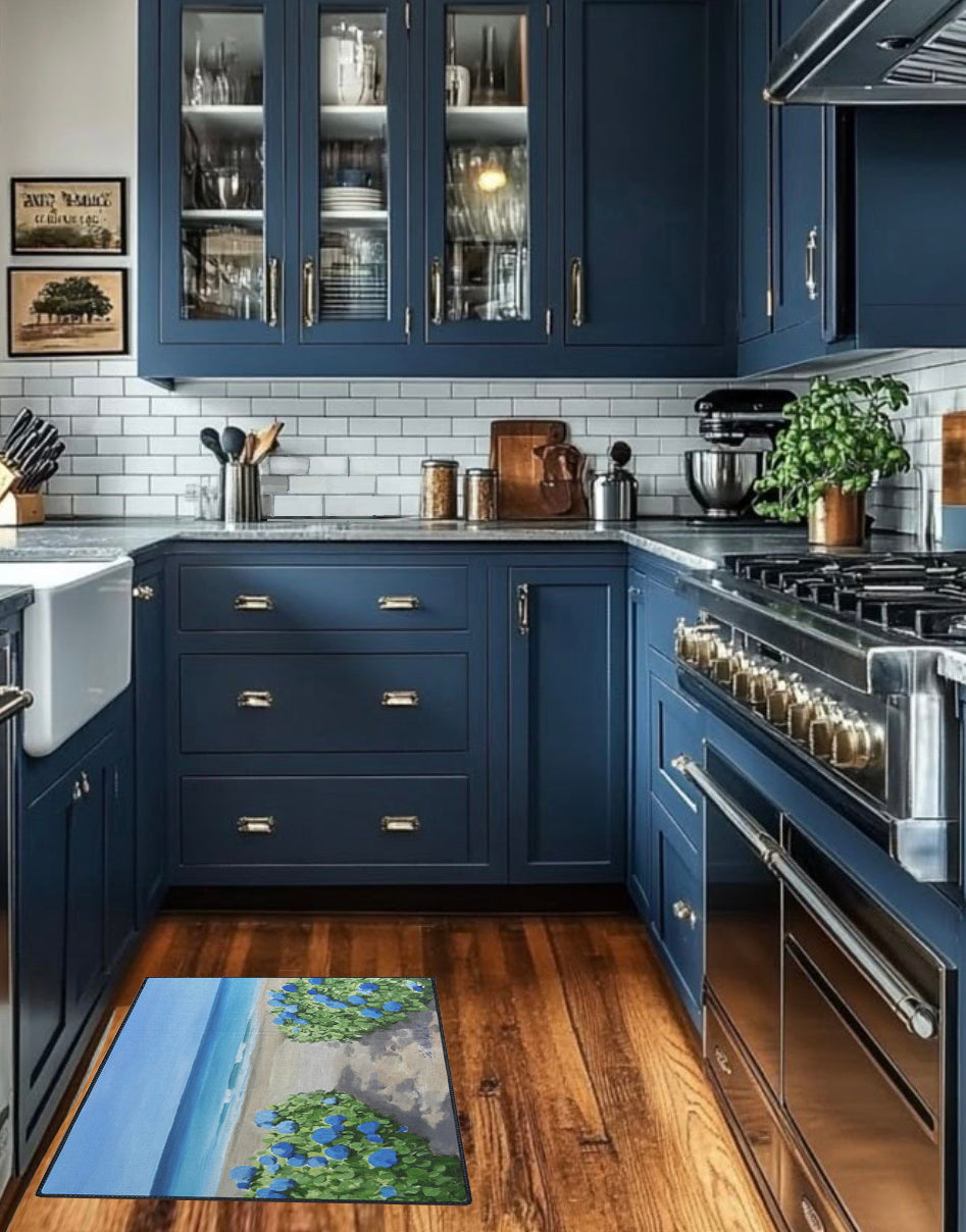 Modern kitchen with blue cabinets, stainless steel appliances, and a decorative rug on the floor.
