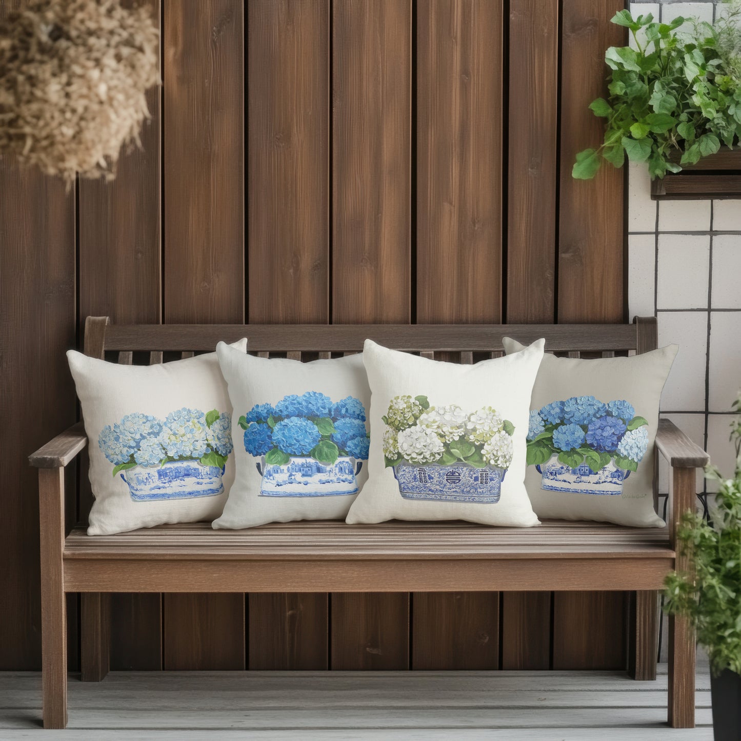 Decorative pillows with floral patterns on a wooden bench against a wooden wall.