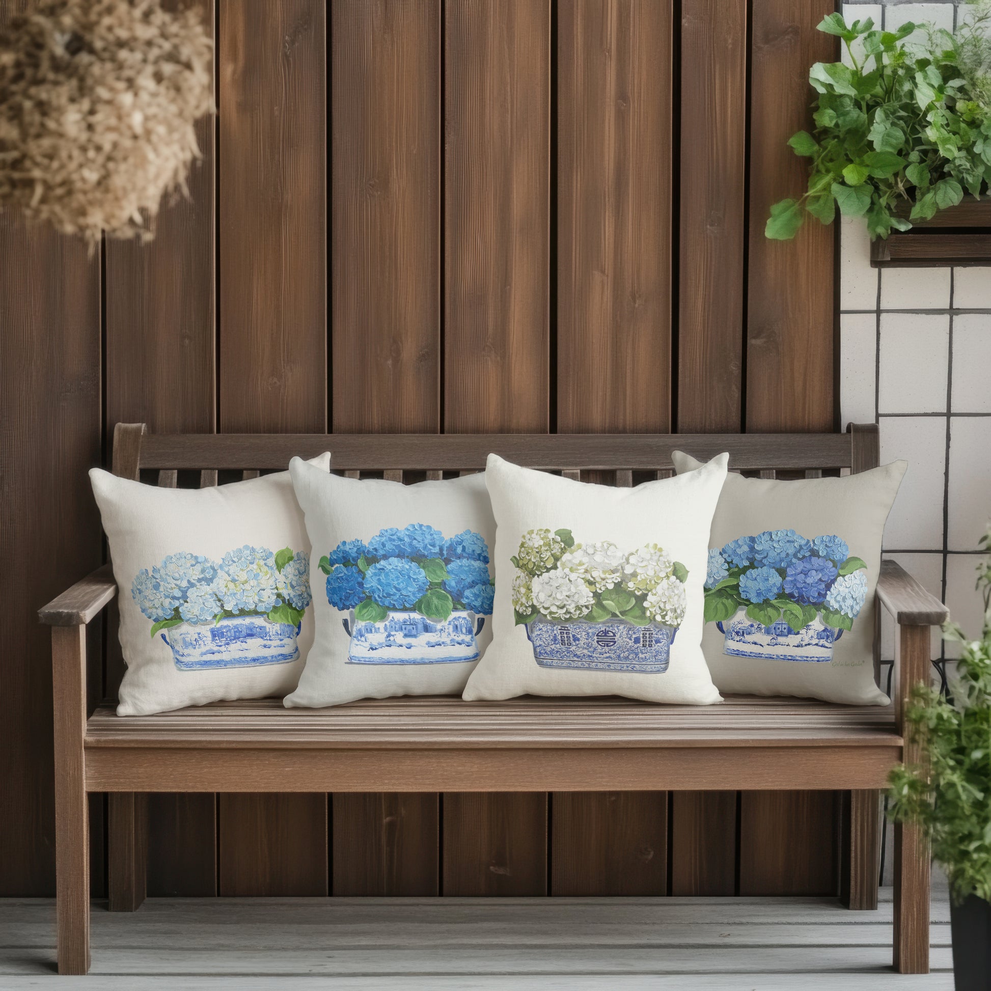 Decorative pillows with floral patterns on a wooden bench against a wooden wall.