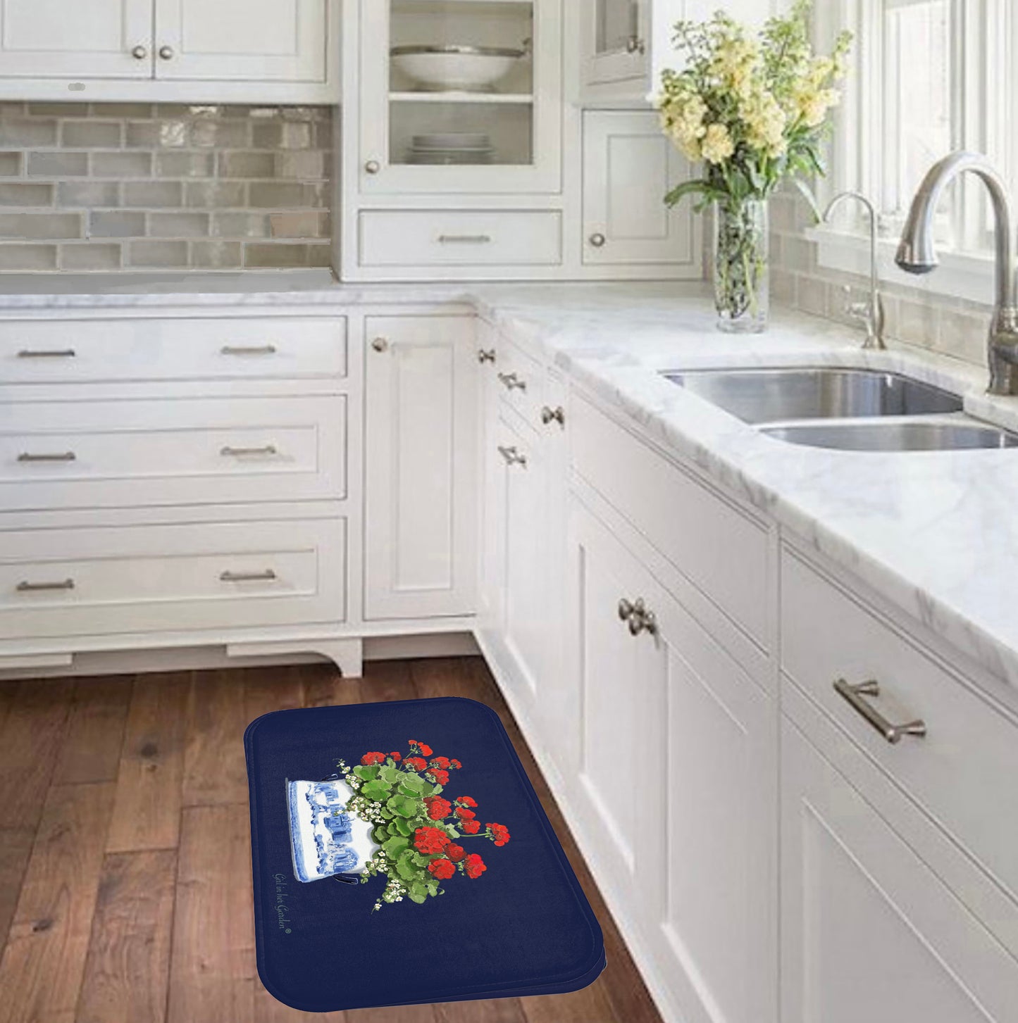 Navy blue rug with floral design on a wooden floor in a kitchen.
