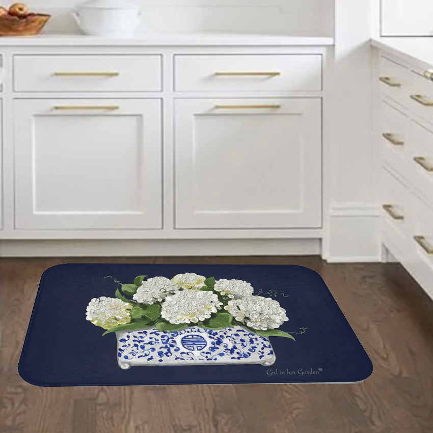 Decorative rug with floral design on a wooden floor in a kitchen setting