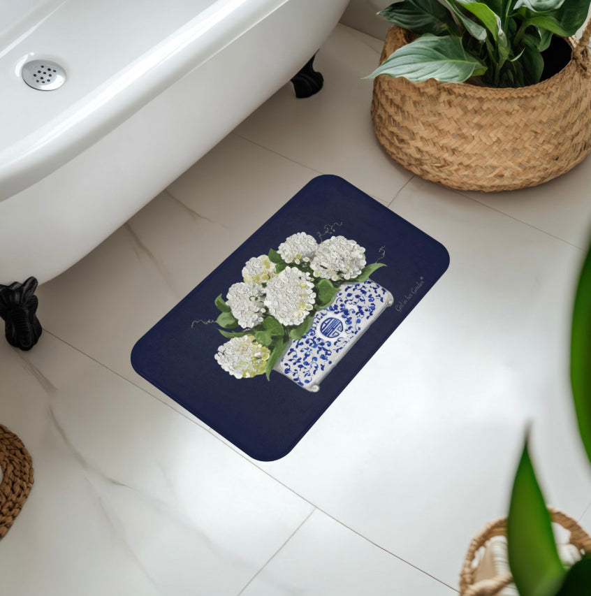 Bath mat with floral and vase design on a bathroom floor